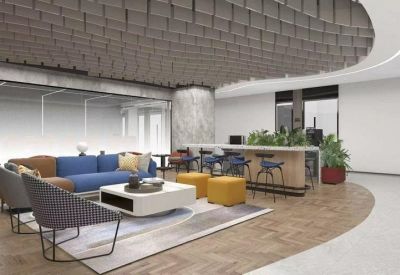 Spacious lounge with a blue sectional sofa, yellow ottomans, and a unique textured ceiling.
