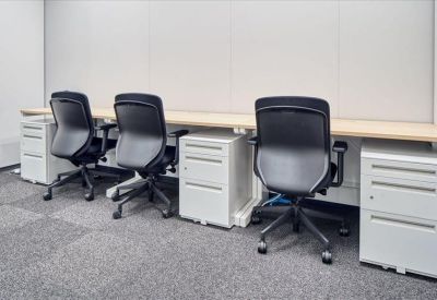 Private office suite with three black ergonomic chairs and white storage units.