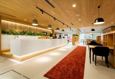 Sleek white reception desk featuring built-in planters and warm under-counter lighting.