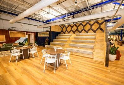 Tiered wooden stadium seating in a breakout area for presentations or casual meetings.