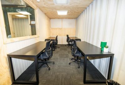 Private four-person office suite housed within a white industrial container.