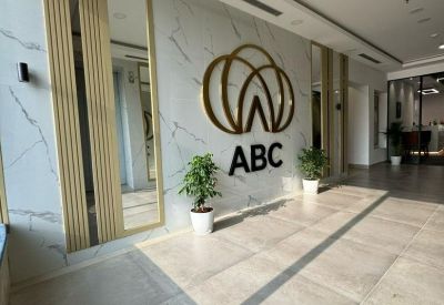 Branded reception area with marble walls and a gold logo.