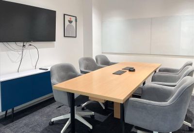 Professional meeting room at Site3, Timber Market, Sector 26, Chandigarh with a light wood table and grey chairs.