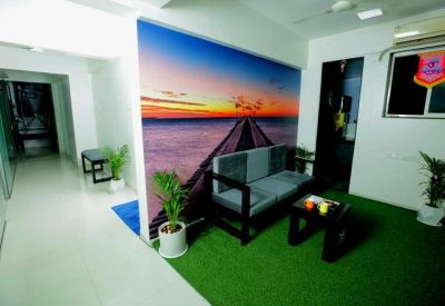 Waiting area with a landscape mural and synthetic grass flooring.