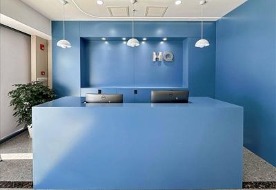 Clean and professional reception area with a blue desk and minimalist lighting.