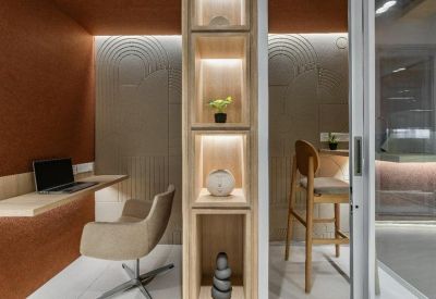 Private phone booths or focus rooms with wooden shelving and acoustic wall panels.