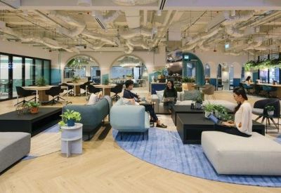 Spacious communal lounge at The Centrepoint, Levels 4 & 6, 176 Orchard Road, Singapore with modern sofas and exposed pipes.