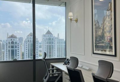 Private office suite for two people featuring high-back ergonomic chairs and a city view.