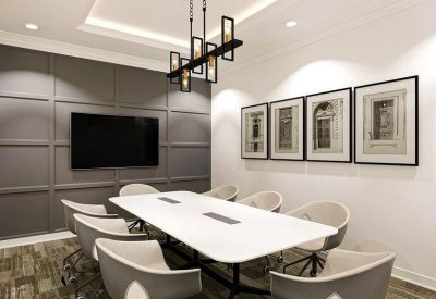 Modern conference room with an eight-person table and a large wall-mounted monitor.