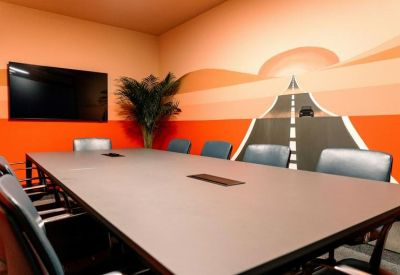 Meeting room with orange feature wall depicting a road receding into the distance.