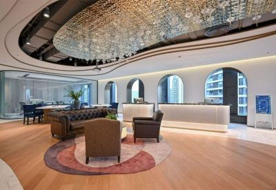 Elegant reception area with a crystal chandelier and plush velvet seating.