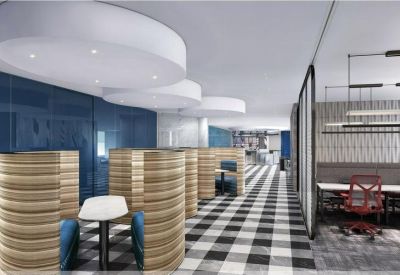 Breakout area featuring semi-enclosed wooden booths and a black and white checkered floor.