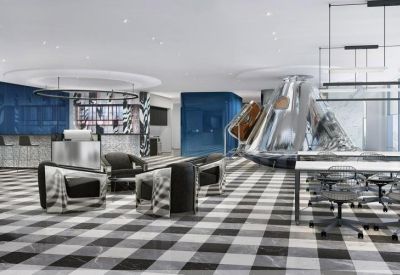 Spacious reception area with a sleek silver desk and a unique metallic pod structure.