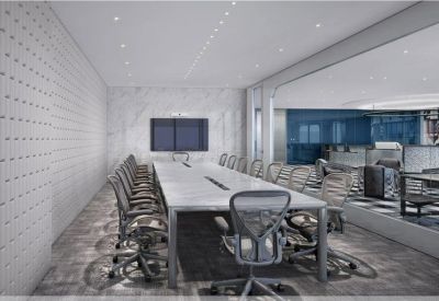 Modern boardroom with a long white table, ergonomic grey chairs, and a marble feature wall.