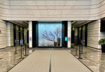 Sleek office lobby featuring a modern art installation and marble flooring.