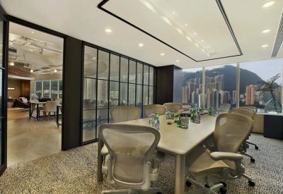 Modern boardroom featuring a large table, mesh chairs, and floor-to-ceiling city views.