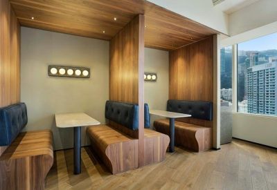 Private wooden seating booths with padded benches and personal tables.