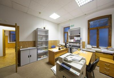 Clinical private office with wooden desks and a large printer.