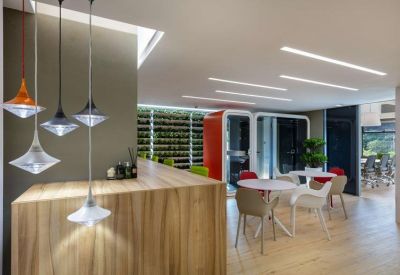Sleek reception area with a wooden front desk and stylish pendant lighting.