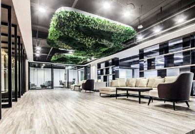Stylish lobby lounge with a cream sectional sofa and hanging greenery.