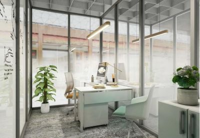 Private glass-walled office suite with a white desk and light-colored furnishings.