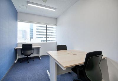 Bright private office featuring a blue accent wall and city views.