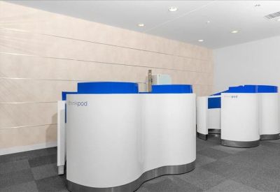 Curved white and blue reception pods in a modern lobby.