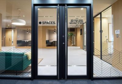 Modern glass entrance doors with bold black frames and geometric patterns.