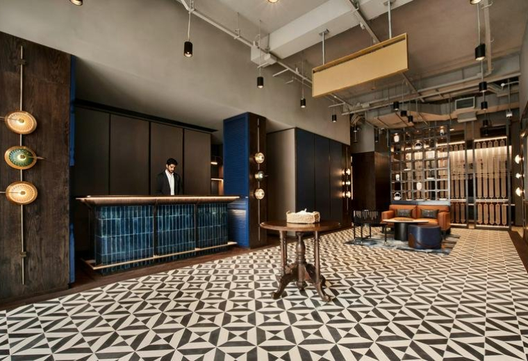 Reception area at 269 South Bridge Road, Singapore featuring a blue tiled desk and geometric patterned floor.
