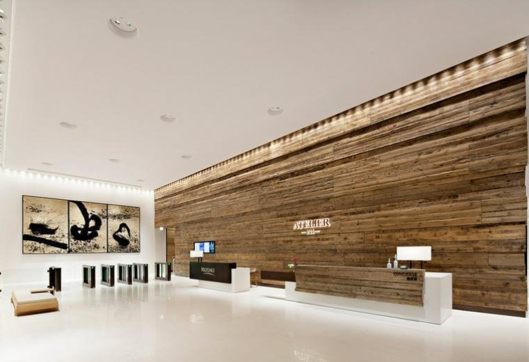 Sleek office reception at K11 Atelier with a rustic wood-plank feature wall.