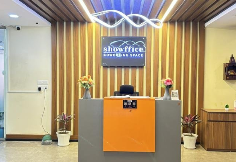 Modern reception area at 8th Floor, Lucknow, India with wood-slat walls and orange accents.