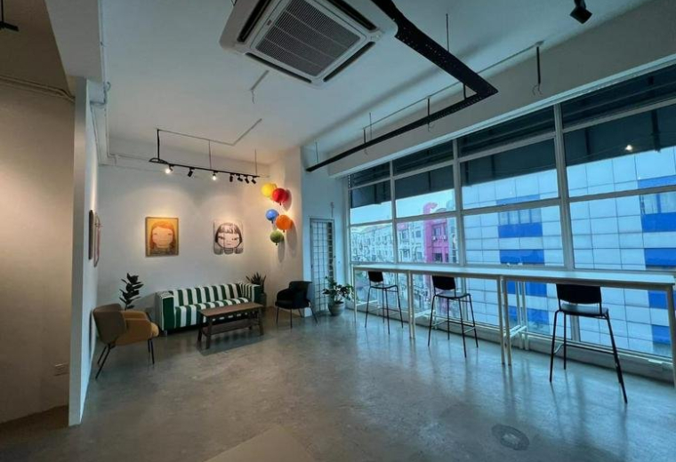 Spacious communal lounge at Number 8, 2, Jalan Radin Bagus 8, Kuala Lumpur featuring a striped sofa and window bar.