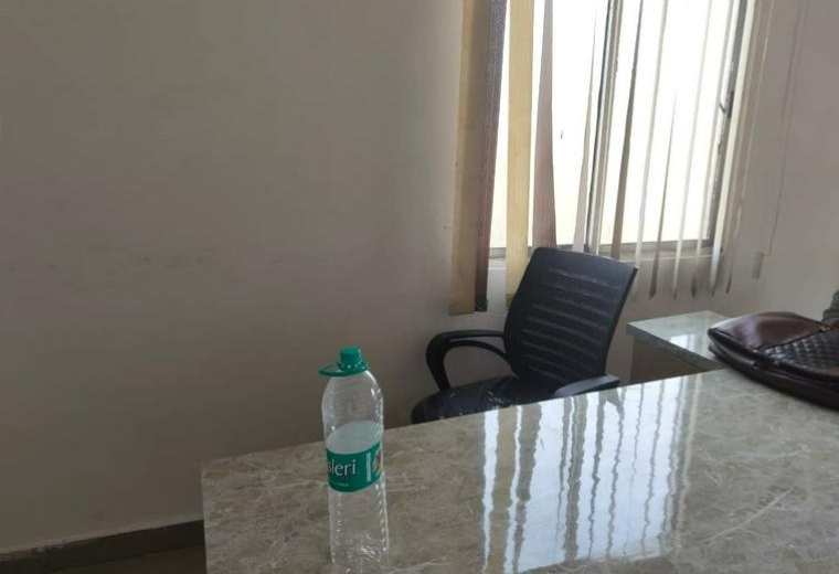Brightly lit workspace at the Anantham Building, 101, 1st Floor, Kokar Chowk featuring marble-patterned desks.