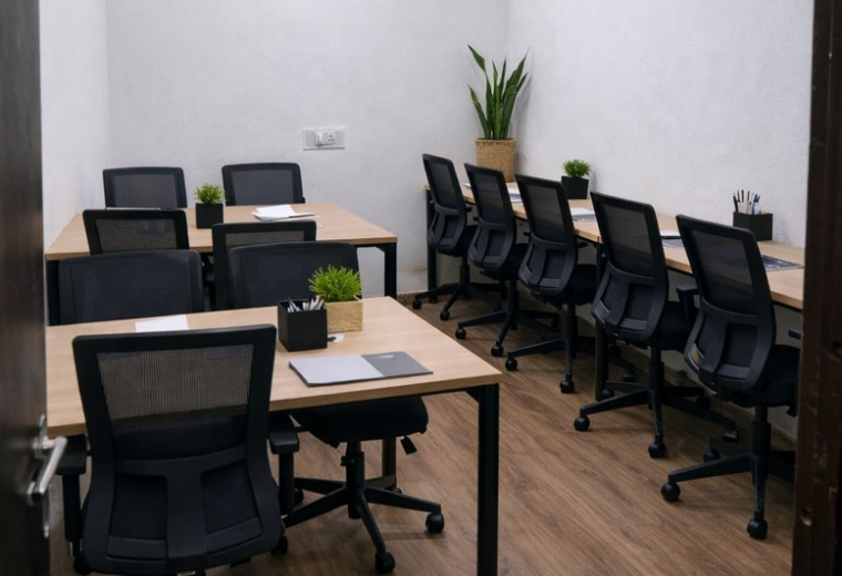 Workspaces at Leo Workspace, H. NO- 35, Khargapur, Gomti Nagar, featuring wooden floors and black mesh chairs.
