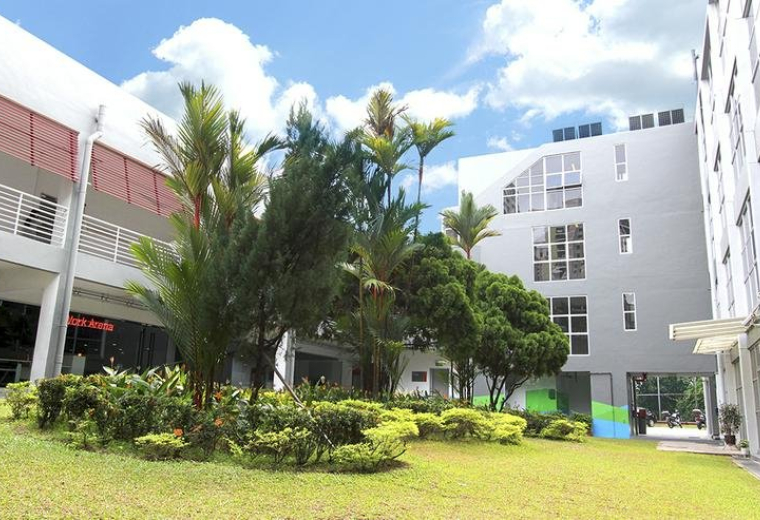 Exterior view of the contemporary white and grey buildings at 10 Raeburn Park.