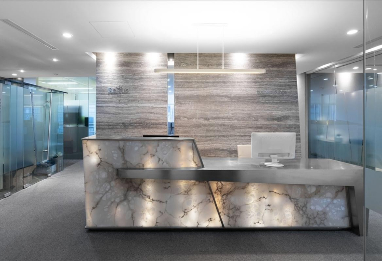 The sleek, stone-clad reception desk at Central Towers, 567 Lan Gao Road, Shanghai.