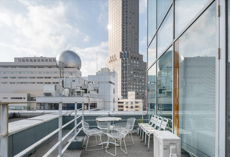 Exterior view of the modern multi-story Fuji building 40 with a glass and tile facade.