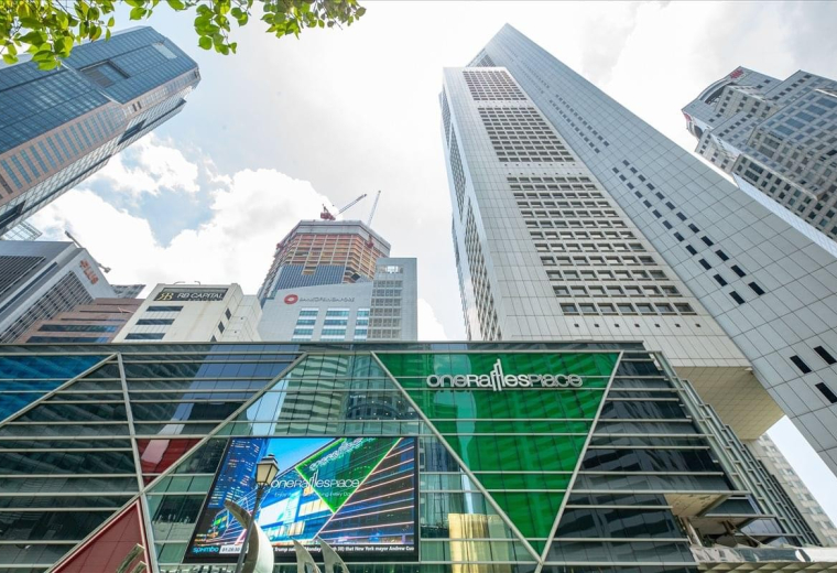 Looking up at the modern glass and stone skyscraper of One Raffles Place, Tower 2.