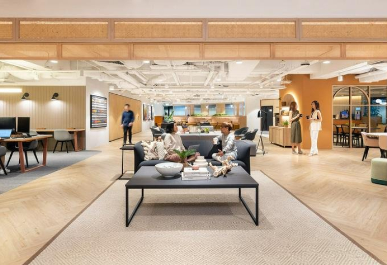 Spacious communal lounge at International Plaza with warm wood accents and contemporary furniture.