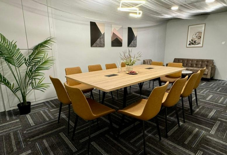 Spacious meeting room with a wooden table, yellow chairs, and modern lighting at 10 Anson Road, No. 33-15, Singapore.
