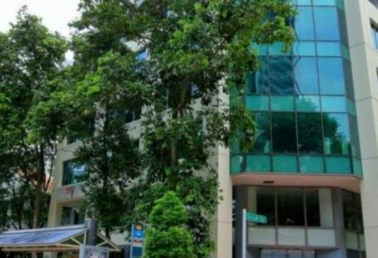 Exterior view of the glass-facade Crasco Building at 11 Beach Road.