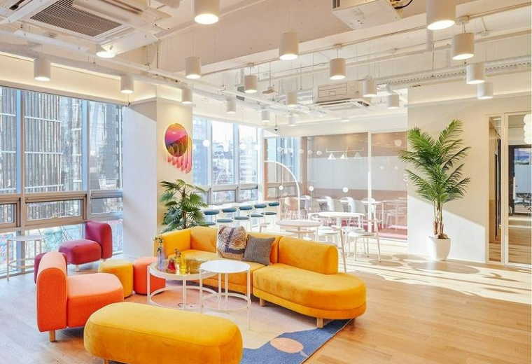 Spacious sunlit lounge with vibrant orange and yellow sofas at 145 Dosan-daero, Sinsa 1.