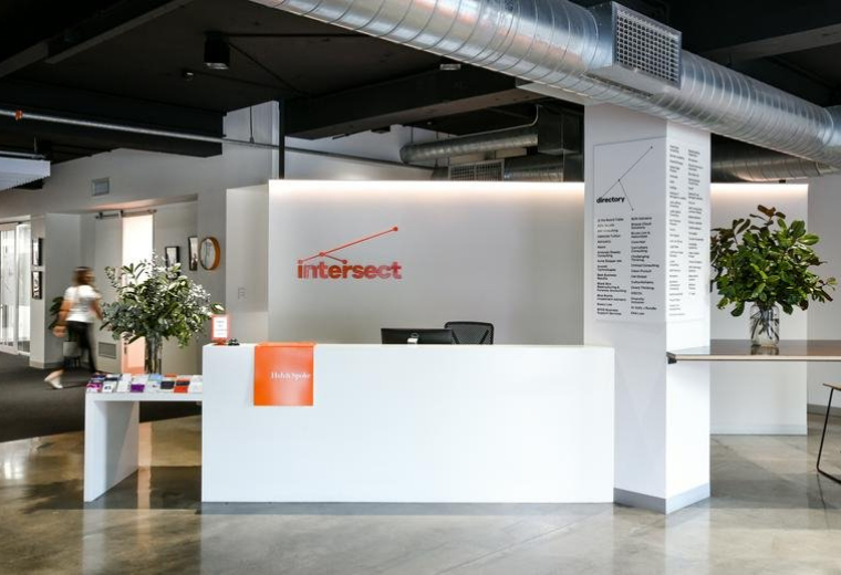 Modern white reception desk with Intersect logo at 167 Flinders Street, Adelaide City.