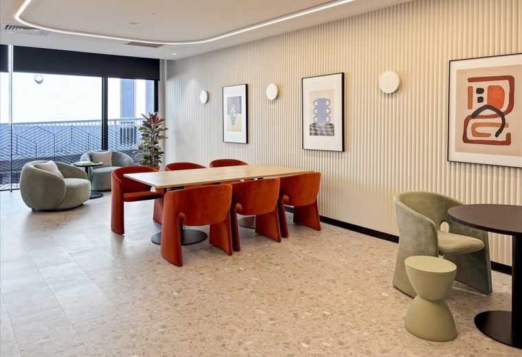 Spacious communal lounge at 2-3 Greenhill Road, Wayville, with orange chairs, terrazzo floors, and natural light.