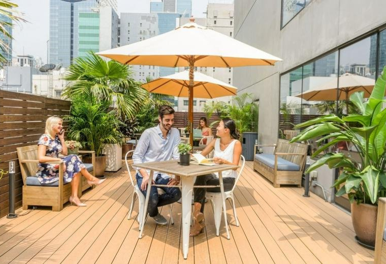 Spacious rooftop terrace with umbrellas and seating at 21/F The Phoenix Building, 23 Luard Road, Hong Kong.