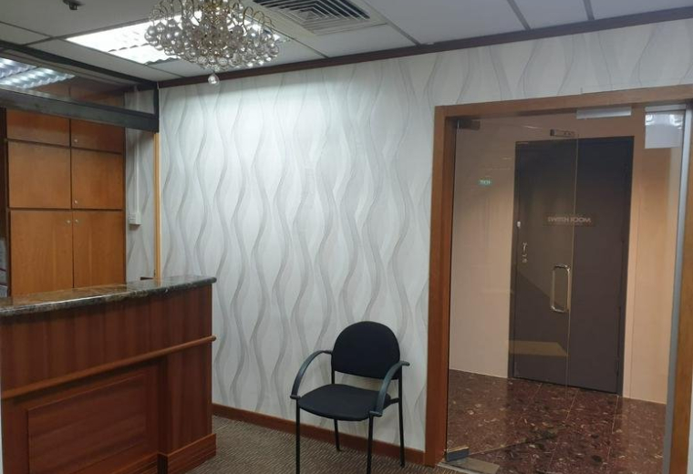 Reception entrance featuring a glass door and a small crystal chandelier.