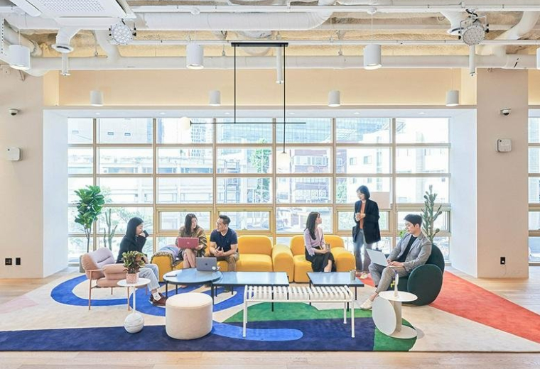 Spacious communal lounge with colorful rugs and natural light at 4-7F, 398, Seocho-daero, Seoul.