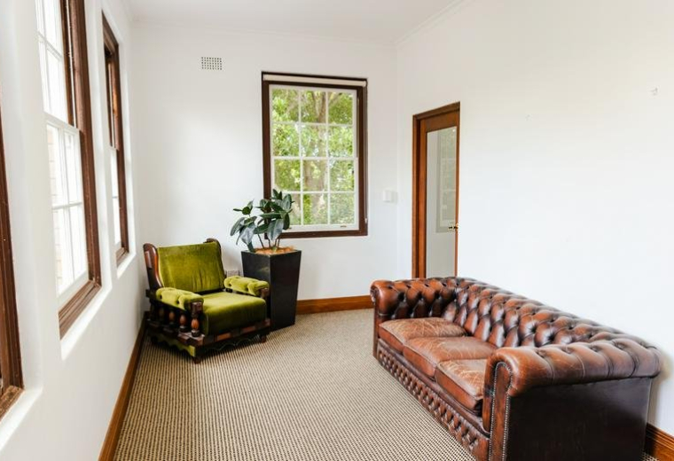 Lounge area at 44 & 46, The Barracks Precinct, North Head Sanctuary, Sydney with vintage velvet and leather seating.