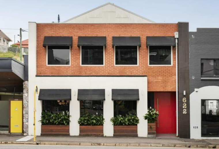 Exterior view of the brick and white facade at 622 Wickham Street.