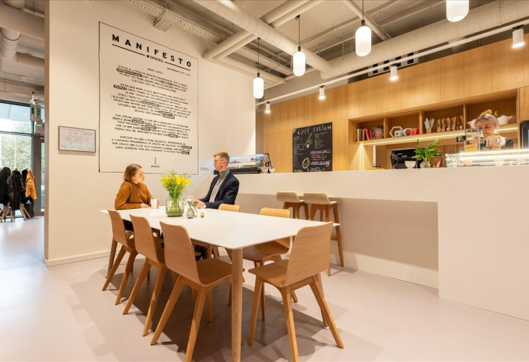Spacious communal dining area at De Yue Windows of Knowledge with wooden chairs and modern hanging lights.